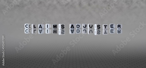 claims adjuster word or concept represented by black and white letter cubes on a grey horizon background stretching to infinity