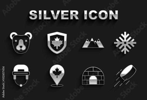Set Canadian maple leaf, Snowflake, Hockey puck, Igloo ice house, helmet, Mountains, Bear head and Canada flag on shield icon. Vector