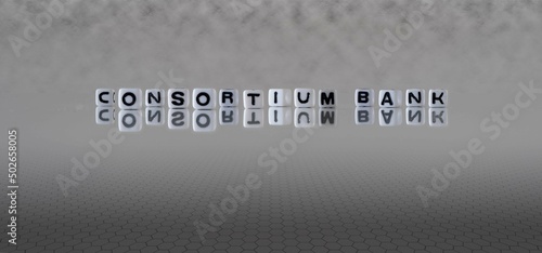 consortium bank word or concept represented by black and white letter cubes on a grey horizon background stretching to infinity photo