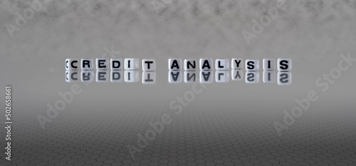 credit analysis word or concept represented by black and white letter cubes on a grey horizon background stretching to infinity