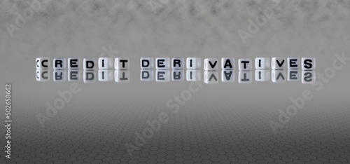 credit derivatives word or concept represented by black and white letter cubes on a grey horizon background stretching to infinity