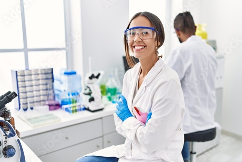 Fototapeta Naklejka Na Ścianę i Meble -  Man and woman scientist partners smiling confident working at laboratory