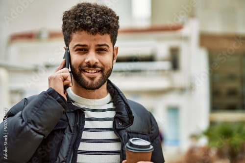 Young arab man speaking on the phone outdoor at the town