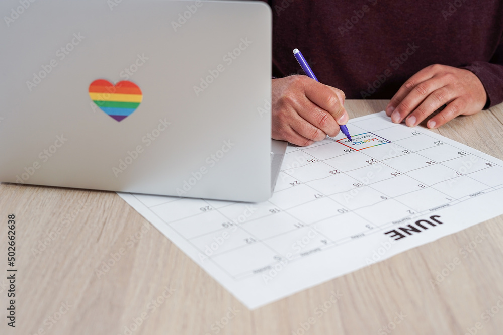 Unrecognizable mature man marking on a calendar the date of the