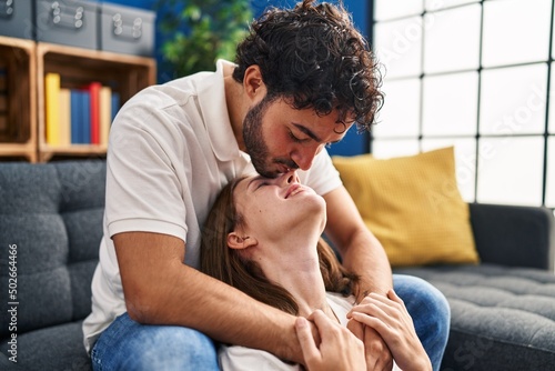 Man and woman kissing nose hugging each other at home