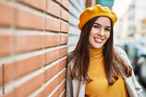 Young hispanic girl smiling happy standing at the city.