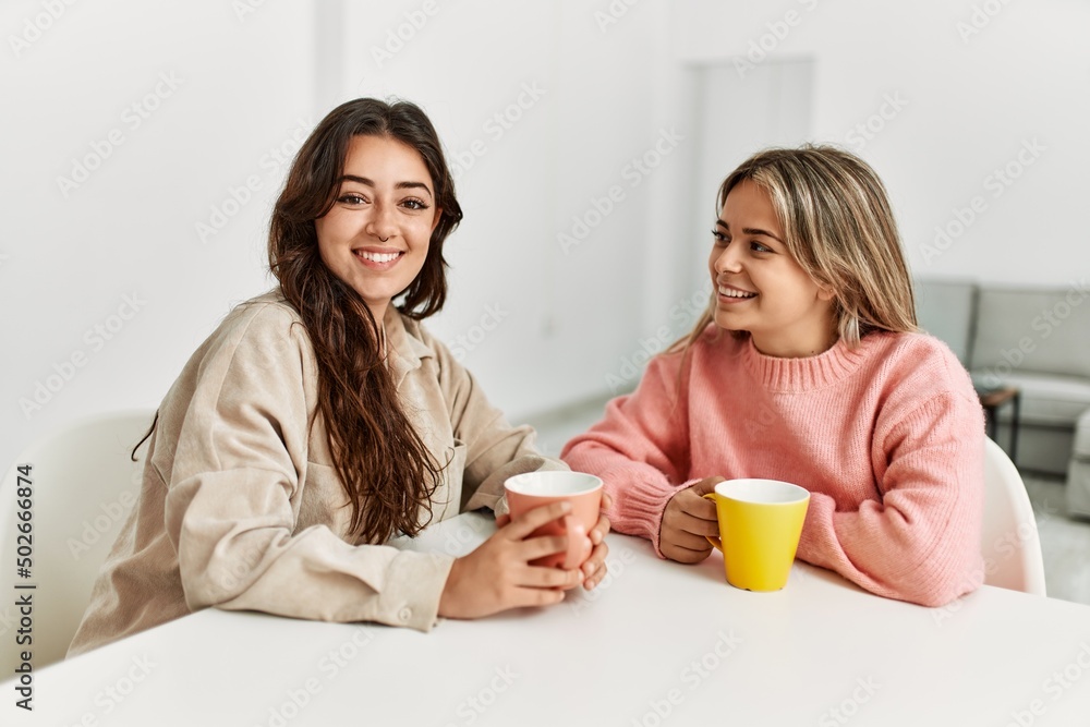 Young beautiful couple smiling happy drinking coffee at home. Young beautiful couple smiling happy drinking coffee at home.