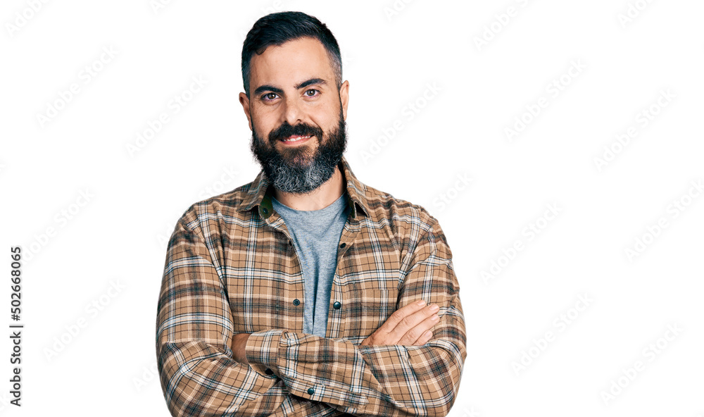 Hispanic man with beard wearing casual shirt happy face smiling with crossed arms looking at the camera. positive person. Hispanic man with beard wearing casual shirt happy face smiling with crossed arms looking at the camera. positive person.