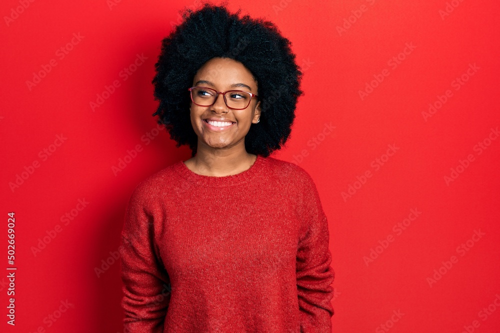 Young african american woman wearing casual clothes and glasses looking to side, relax profile pose with natural face and confident smile. Young african american woman wearing casual clothes and glasses looking to side, relax profile pose with natural face and confident smile.