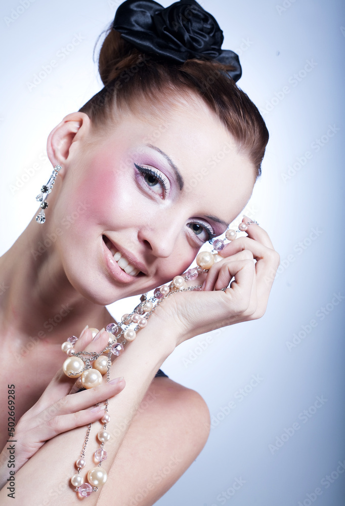 Vintage, retro style: Young woman with big pearl beads, beauty and youth.