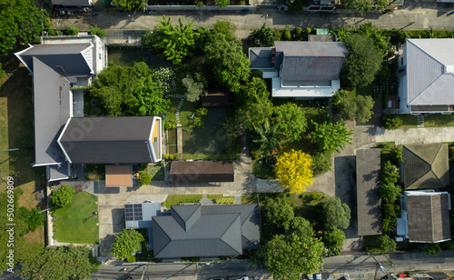 Aerial view of the roof of a house with a car taken by a drone, top view of road