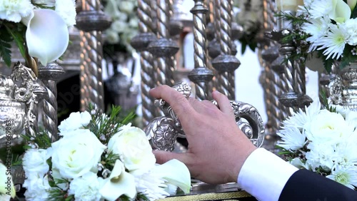 Detail of the knocker or llamador at the moment when it is hit by the foreman of the brotherhood to lift the Holy Week platform or throne