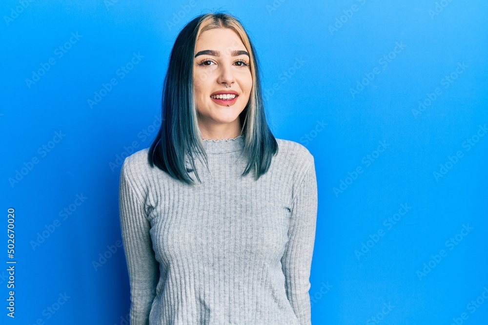 Young modern girl wearing casual sweater with a happy and cool smile on face. lucky person. Young modern girl wearing casual sweater with a happy and cool smile on face. lucky person.