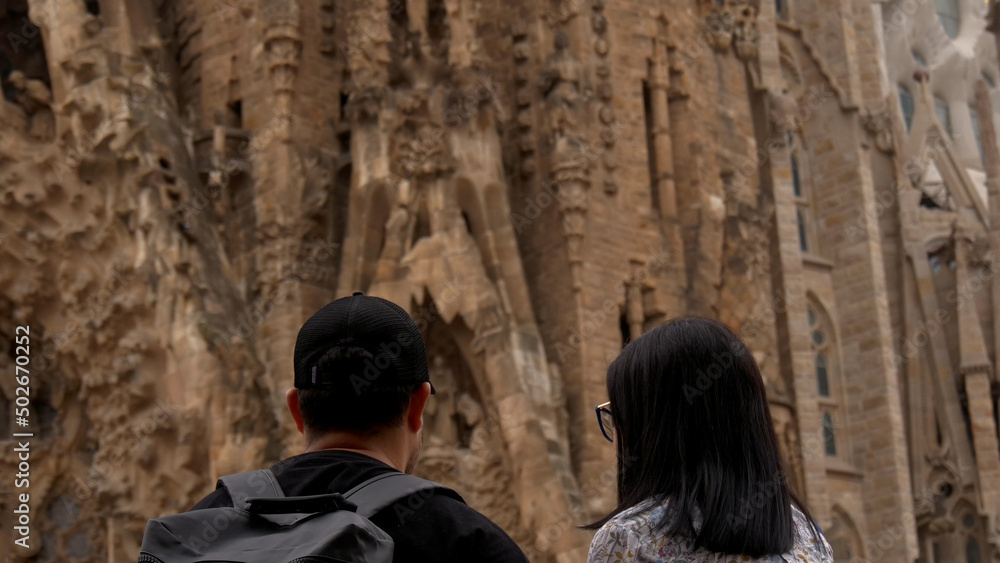Couple of tourists in love with the Sagrada Familia in Barcelona, Spain