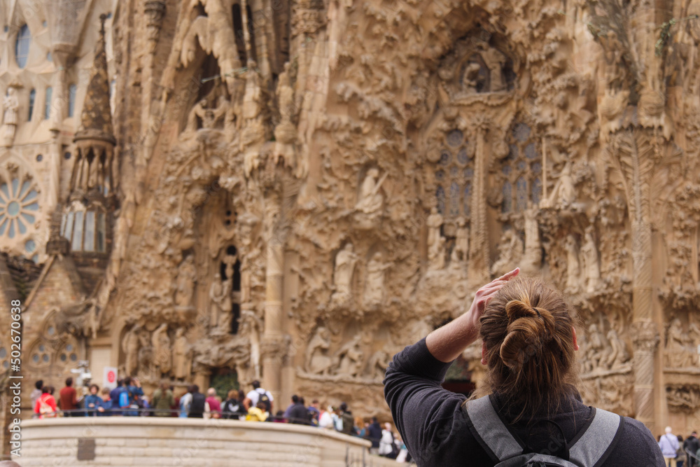 Tourist is mesmerized by the Sagrada Familia, Barcelona, Catalonia, Spain