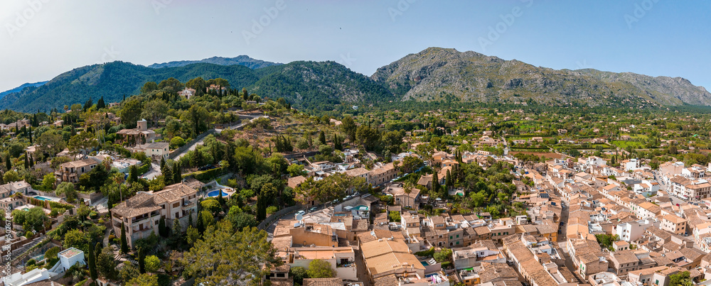 Aerial view of Pollenca, Mallorca, Spain. Small town with a view into a green and rocky landscape.