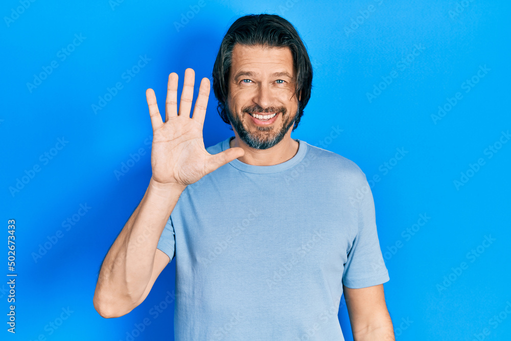 Middle age caucasian man wearing casual clothes showing and pointing up with fingers number five while smiling confident and happy. Middle age caucasian man wearing casual clothes showing and pointing up with fingers number five while smiling confident and happy.