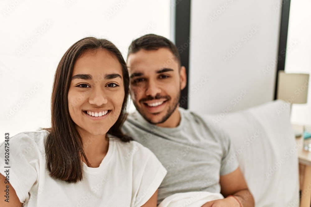 Young latin couple smiling happy hugging on the bed at home. Young latin couple smiling happy hugging on the bed at home.