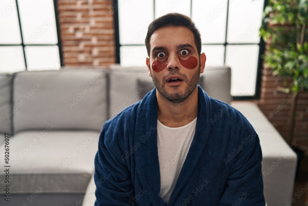 Young hispanic man with beard wearing beauty eyes patch scared and amazed with open mouth for surprise, disbelief face Young hispanic man with beard wearing beauty eyes patch scared and amazed with open mouth for surprise, disbelief face