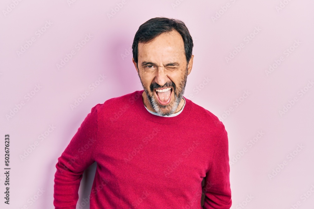 Middle age hispanic man wearing casual clothes winking looking at the camera with sexy expression, cheerful and happy face. Middle age hispanic man wearing casual clothes winking looking at the camera with sexy expression, cheerful and happy face.