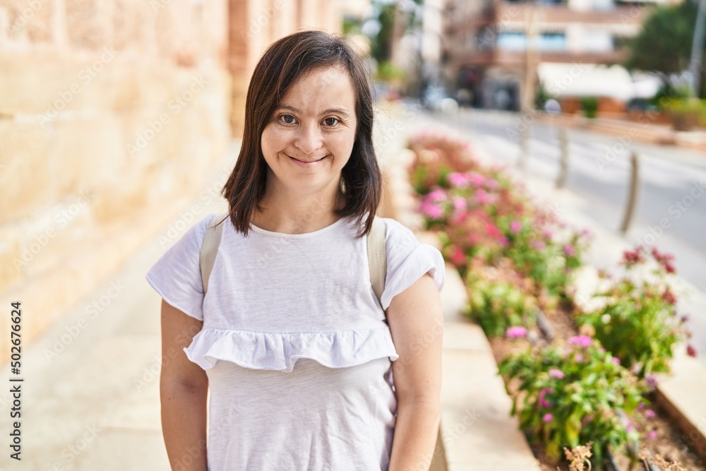 Down syndrome woman smiling confident standing at street Down syndrome woman smiling confident standing at street