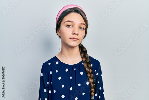 Young brunette girl wearing elegant look relaxed with serious expression on face. simple and natural looking at the camera.