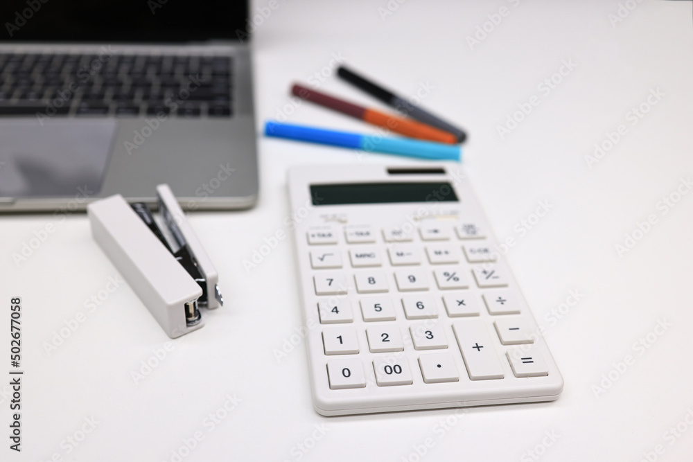 Office stationary note book, pen and laptop , working equipment. office table desk workspace with blank notebook, calculator Office stationary note book, pen and laptop , working equipment. office table desk workspace with blank notebook, calculator