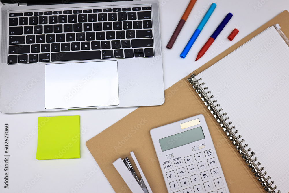 Office stationary note book, pen and laptop , working equipment. office table desk workspace with blank notebook, calculator Office stationary note book, pen and laptop , working equipment. office table desk workspace with blank notebook, calculator