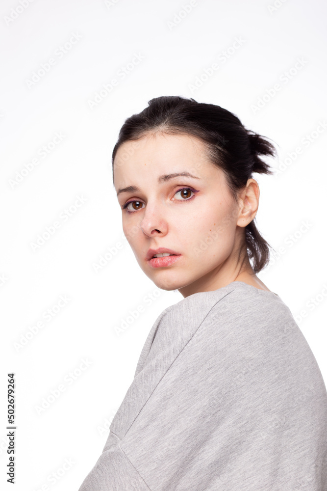 emotional woman in a gray sweatshirt, white background emotional woman in a gray sweatshirt, white background