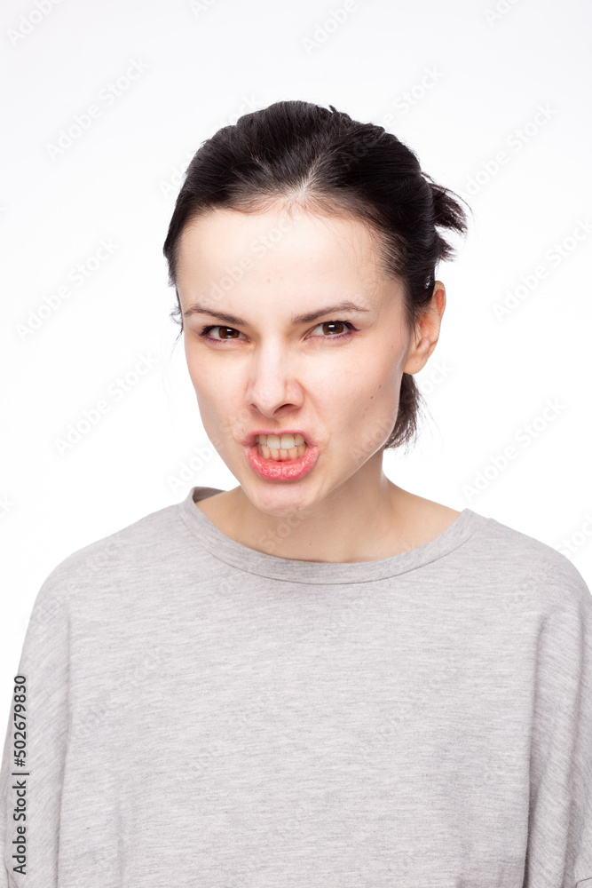 emotional woman in a gray sweatshirt, white background emotional woman in a gray sweatshirt, white background