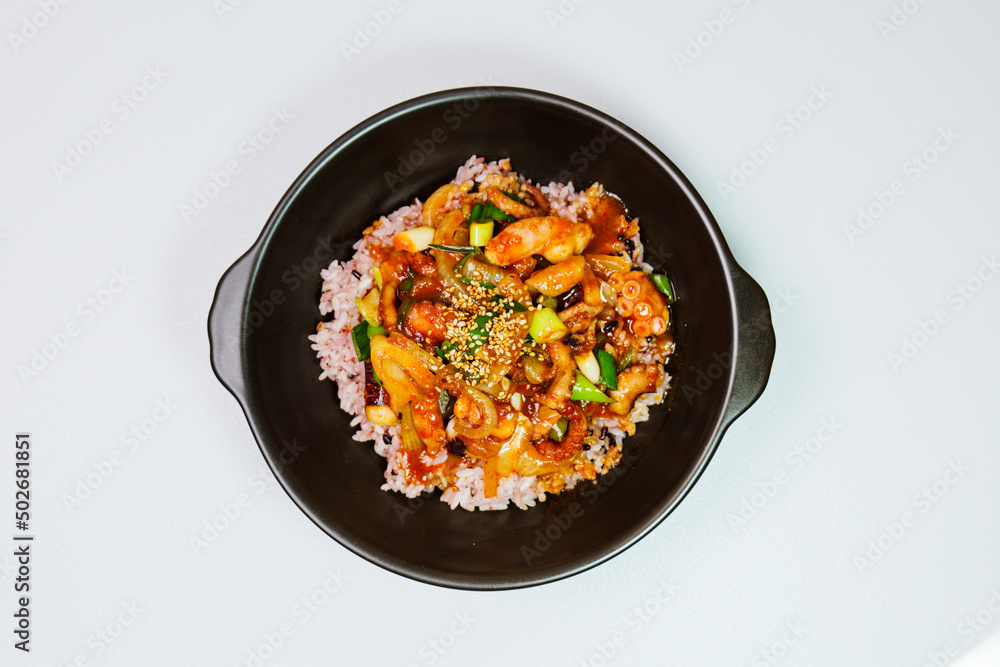 Nakjideopbap, Korean style spicy stir-fried octopus over rice : This dish is made by stir-frying sliced onion and carrots along with sauce over high heat in an oiled pan. Bite-sized pieces of octopus Nakjideopbap, Korean style spicy stir-fried octopus over rice : This dish is made by stir-frying sliced onion and carrots along with sauce over high heat in an oiled pan. Bite-sized pieces of octopus