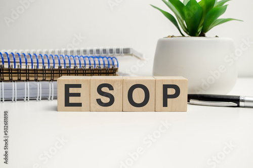 esop sign on the wooden cubes and notepads. Business concept photo