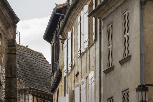 Face of medieval houses in a narrow street of a typical french medieval village and city, bergerac, in France, in the region of Dordogne and Perigord, typical of the Southwestern French architecture