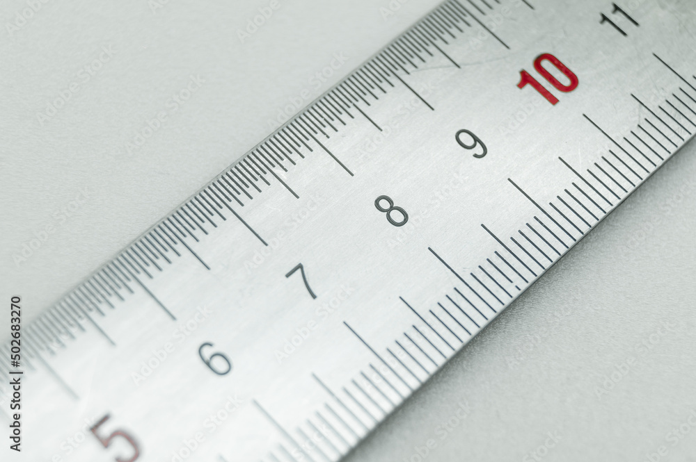 Iron ruler close-up on a white background. Stainless steel ruler. Working tools made of metal and stationery. Selective focus, isolated on white Iron ruler close-up on a white background. Stainless steel ruler. Working tools made of metal and stationery. Selective focus, isolated on white