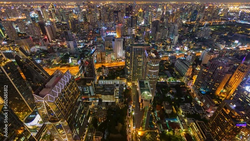 Aerial view of Ploenchit junction with cars traffic skyscraper buildings. Bangkok City in downtown at night, Thailand