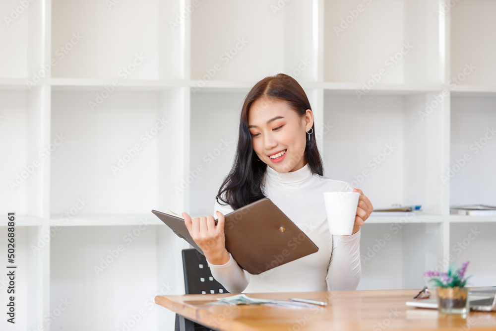 Lifestyle concept, Beautiful asian woman feel relaxing while studying online in coffee shop Lifestyle concept, Beautiful asian woman feel relaxing while studying online in coffee shop