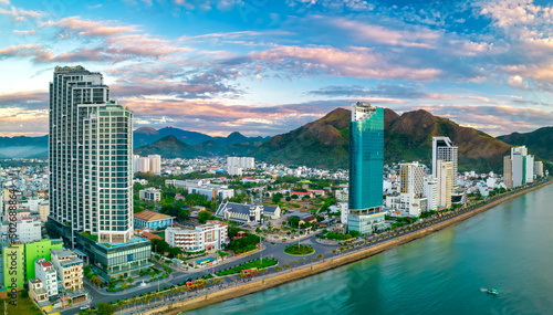 The coastal city of Nha Trang seen from above in the afternoon with its beautiful city and clean sandy beach attracts tourists to visit in Nha Trang, Vietnam © huythoai