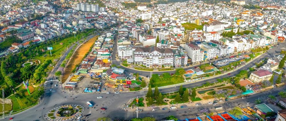 Aerial view of Da Lat city beautiful tourism destination in central highlands Vietnam. Urban development texture, green parks and city lake.