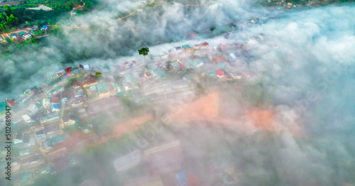 Fototapeta Naklejka Na Ścianę i Meble -  Aerial view of the town in the early morning mist is beautiful in the highlands of Da Lat, Vietnam