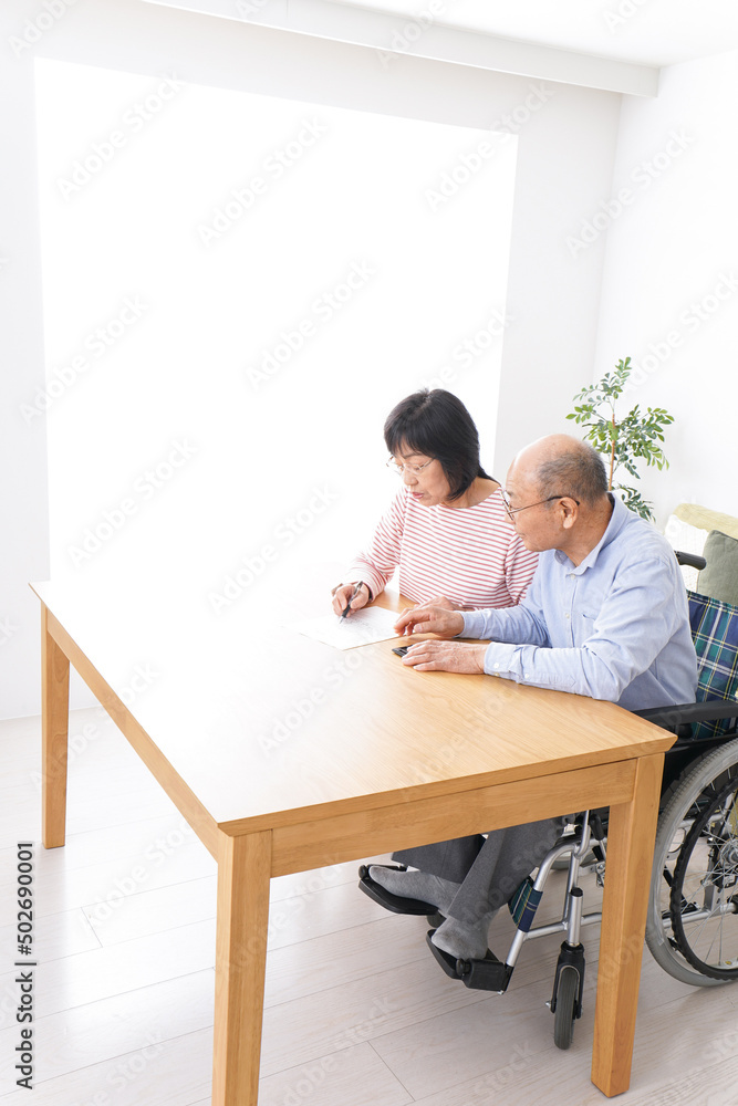 Senior couple signing a document Senior couple signing a document
