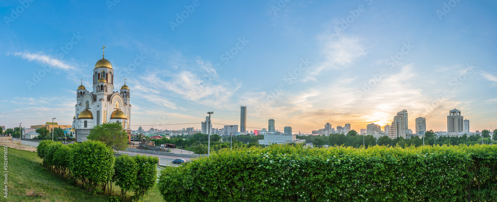 Fototapeta premium Panorama of spring or summer Yekaterinburg and Temple on Blood in orange sunset light. Yekaterinburg, Russia