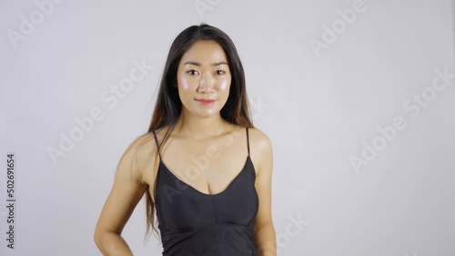 Sexy Asian woman in a black dress  smile with joy on white background