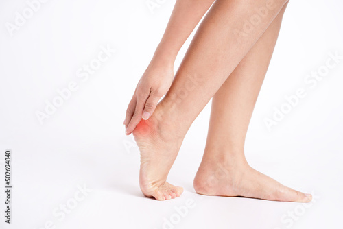 Heel pain , Heel, Hands touching heels on white background. © PBXStudio