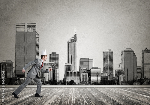 King businessman in elegant suit running and drawn cityscape silhouette at background