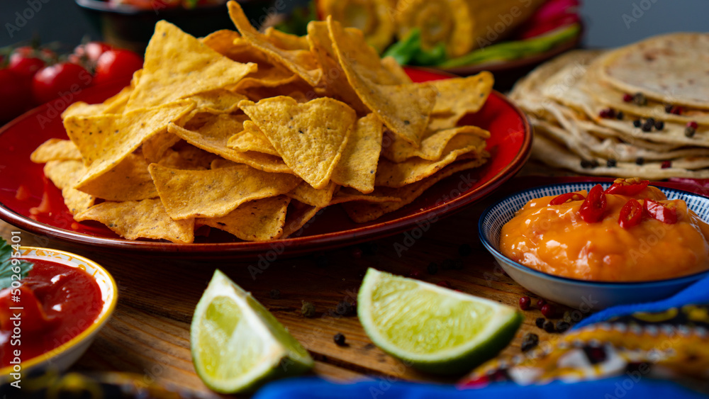 Cinco de mayo mexican holiday. Mexican food Corn Tortillas, Nachos, Salsa sauce. Lime slices Cinco de mayo mexican holiday. Mexican food Corn Tortillas, Nachos, Salsa sauce. Lime slices