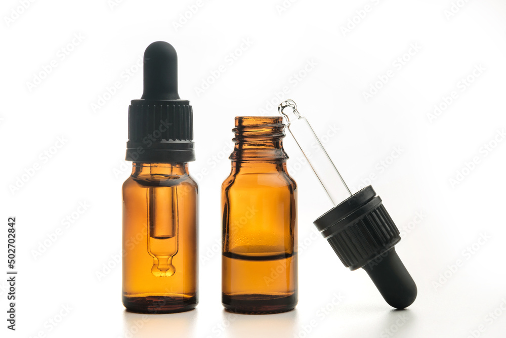 A pair of bottles for essential oils isolated on a white background. A pair of bottles for essential oils isolated on a white background.