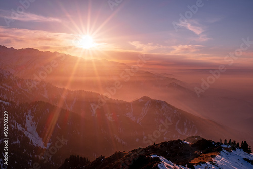 Magical atmosphere of a sunset in the highlands  sunset sky over snow-capped mountain ridges