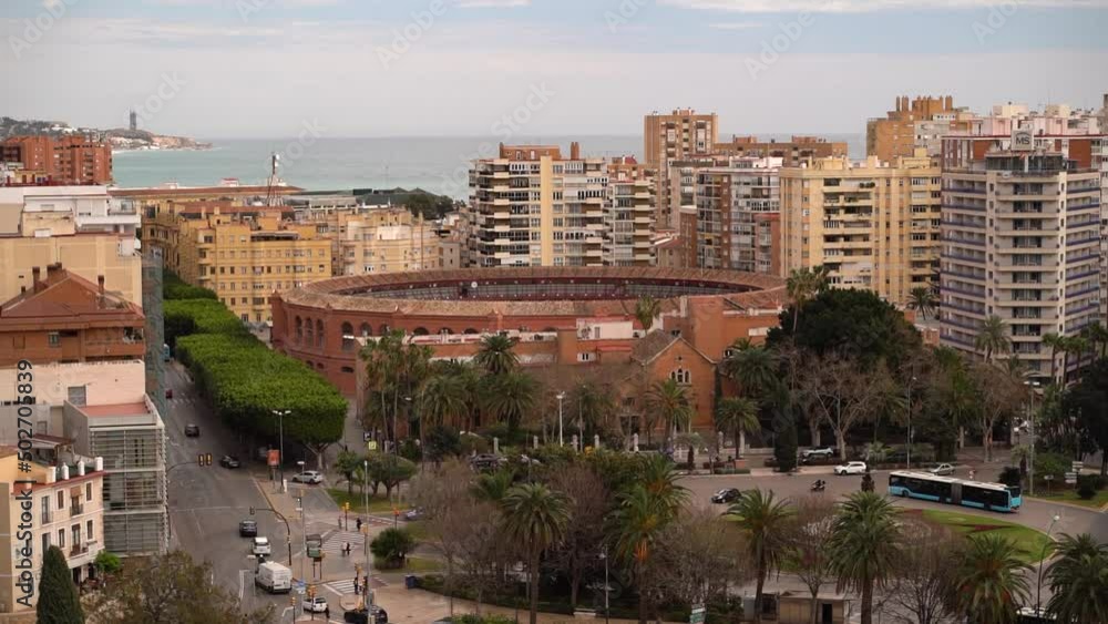 Famous bullfighting arena in Malaga, Spain with skyscrapers in background Famous bullfighting arena in Malaga, Spain with skyscrapers in background