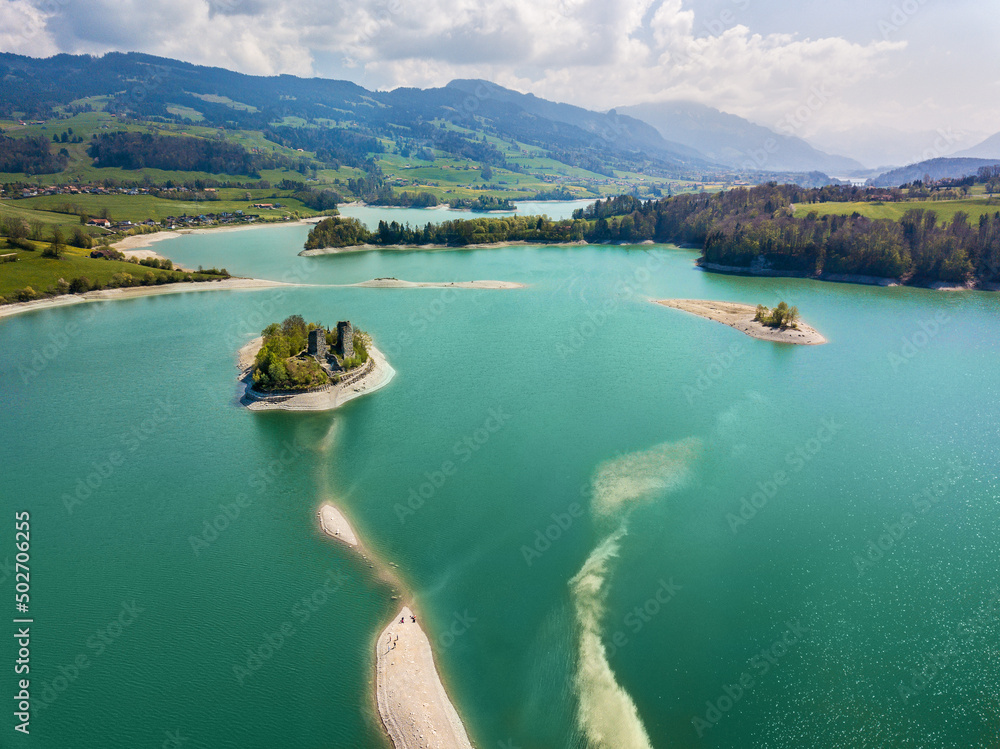 Aerial image of Lake of Gruyere with ruins castle of Pont (or Pont-en-Ogoz) on the Ile d'Ogoz, Canton of Fribourg, Switzerland.