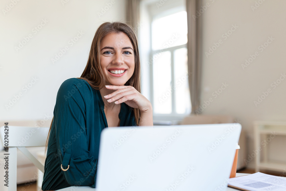 Business woman analyzing data using computer while spending time in the office. Beautiful young grinning professional woman in office. Graphs and charts Business woman analyzing data using computer while spending time in the office. Beautiful young grinning professional woman in office. Graphs and charts